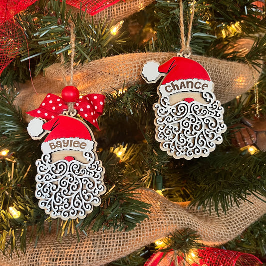 Santa-shaped ornament with a curly beard and red hat hangs on a Christmas tree